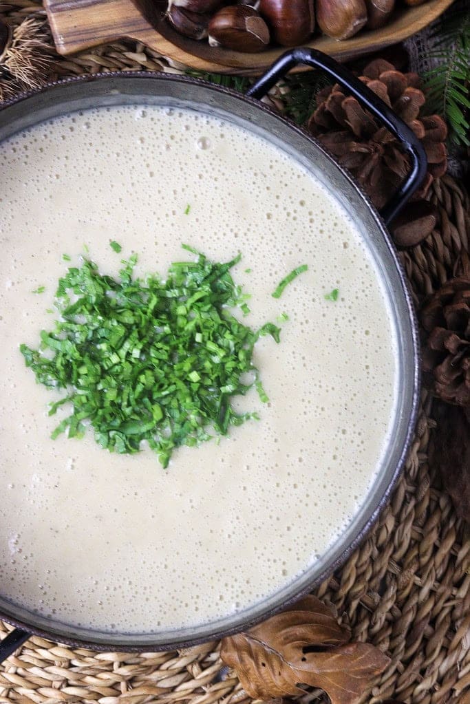 image showing how to add sour cream and parsley and process the soup with a hand mixer